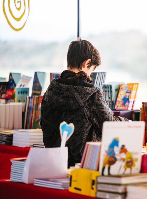 Fête du livre de Bron : petit garçon dans un rayon plein de livres