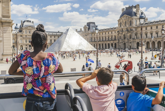 Toot Bus : enfant face à la pyramide du Louvre