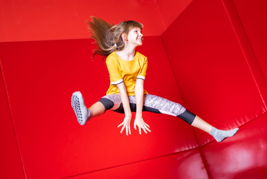 Top trampoline : Une petite fille saute en l'air sur un trampoline
