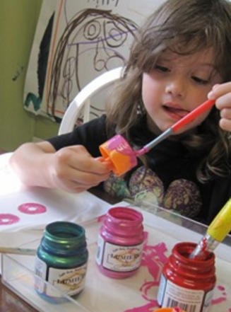 Une enfant customise un t-shirt