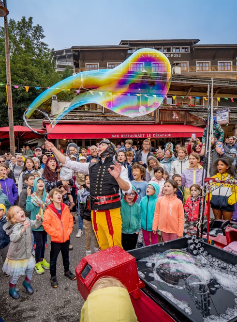 Festival Au Bonheur des Mômes : Des enfants regardent un artiste de rue faire des énormes bulles de savon